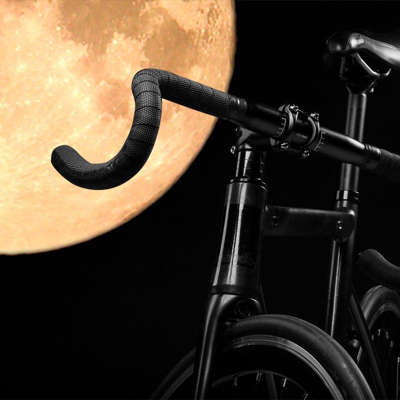 Bike handlebars with full moon in background