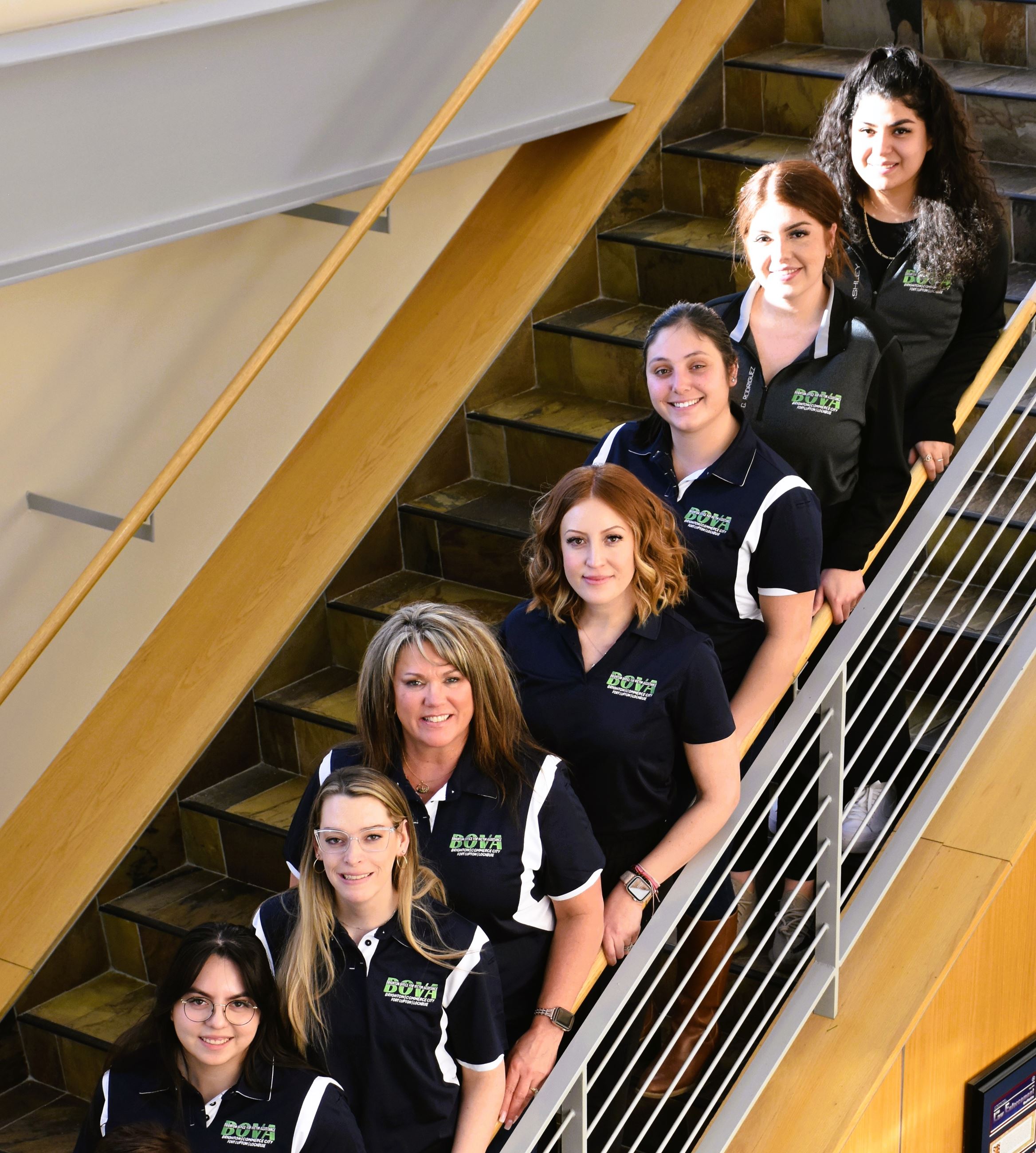 BOVA team members lined up on a staircase, all smiling