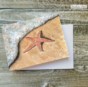 Handmade card with a drawing of a starfish in the surf