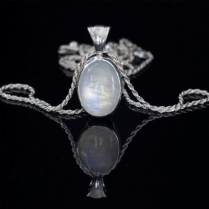 Photograph of a necklace with a white opalescent gem