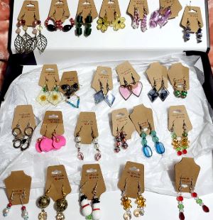Photograph of many handmade earrings. 